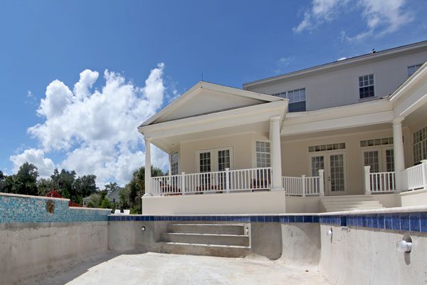 Image of a house with a drained swimming pool in the foreground