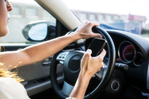 Person using their phone and driving at the same time