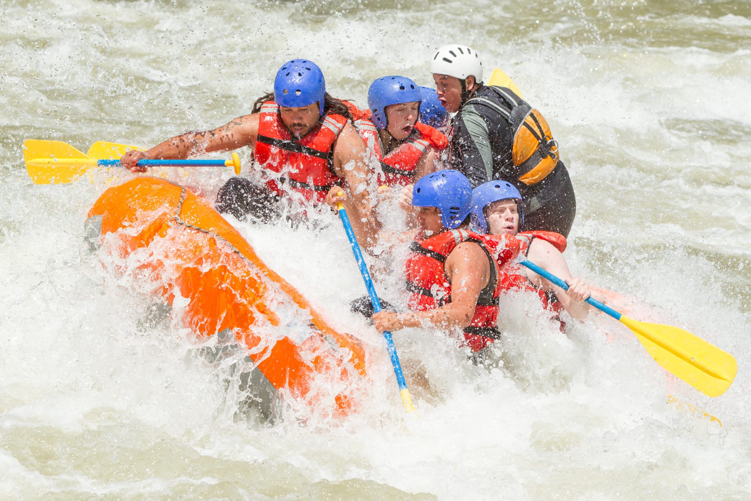 Group of people white water rafting