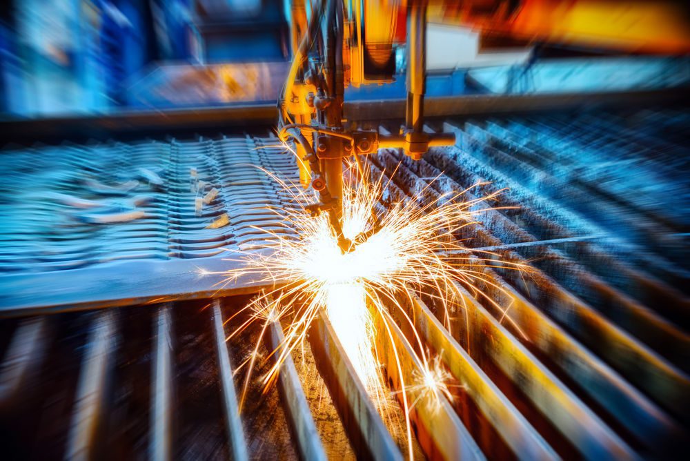 Blurry image of machine welding metal, sparks flying