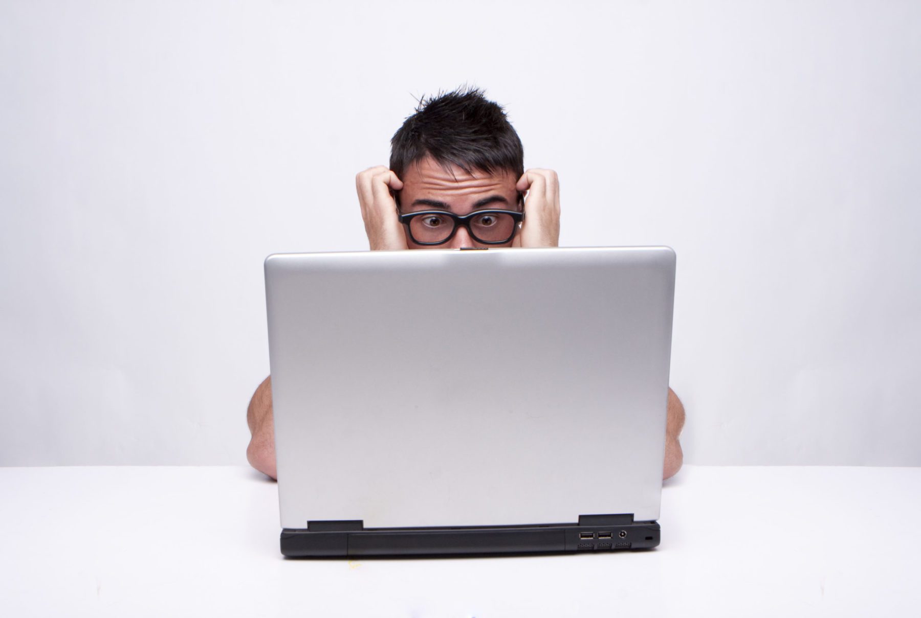 Stressed out man looking at computer