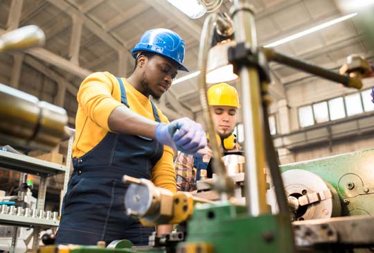 Two men with construction hats on working