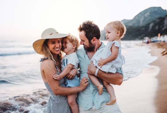 Family laughing together at the beach