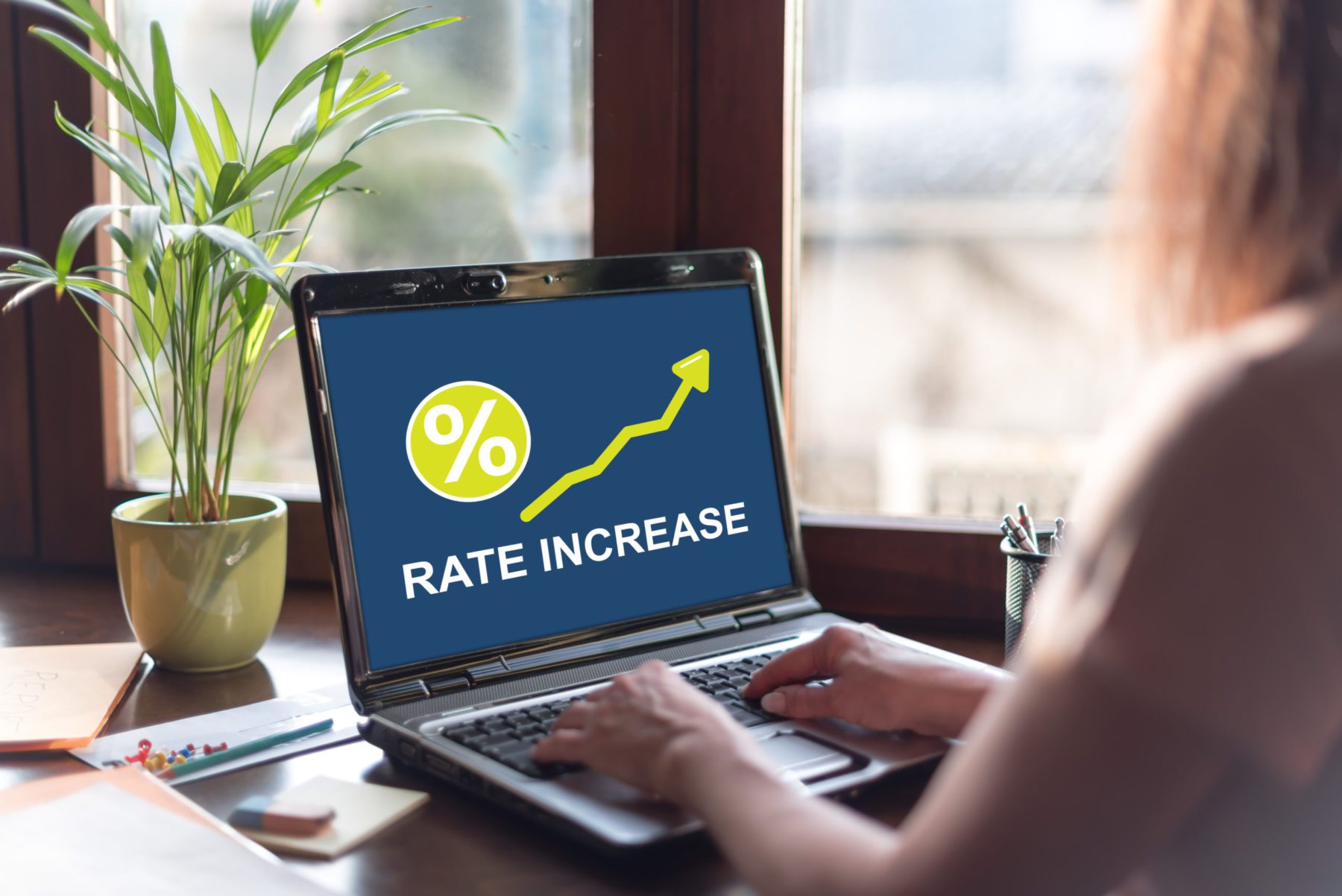 A computer that shows a rate increase on the screen