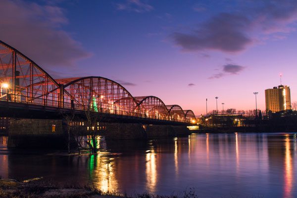 Photo of a bridge over a river, used for the announcement of FCC being acquired by AssuredPartners